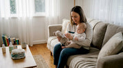 Parent checks label on baby toy at home