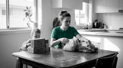 Mother sorting sustainable baby products at home