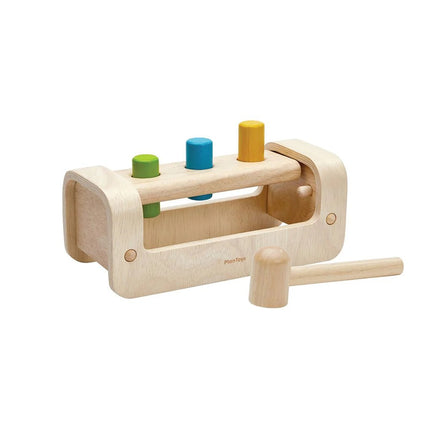 Plan Toys Pounding Bench with wooden mallet and colorful pegs, promotes fine motor skills and sensory development for toddlers.