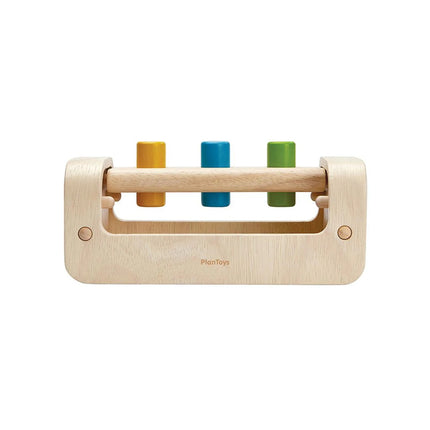 Plan Toys Pounding Bench with pegs and mallet for toddler motor skills and sensory play.