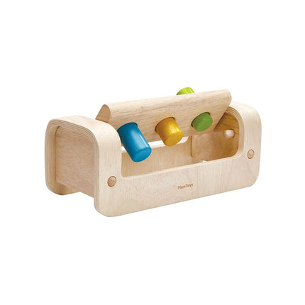 Plan Toys Pounding Bench with wooden mallet and colorful pegs for toddlers, enhancing motor skills and sensory play.